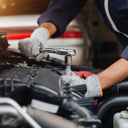 NAPA Auto PartsA mechanic wearing gloves uses a wrench to work on a car engine. The close-up shows focus and precision, conveying a sense of skill and expertise.